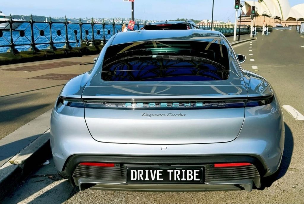 Silver 2021 Porsche Taycan Turbo, rear view, available for hire in Sydney