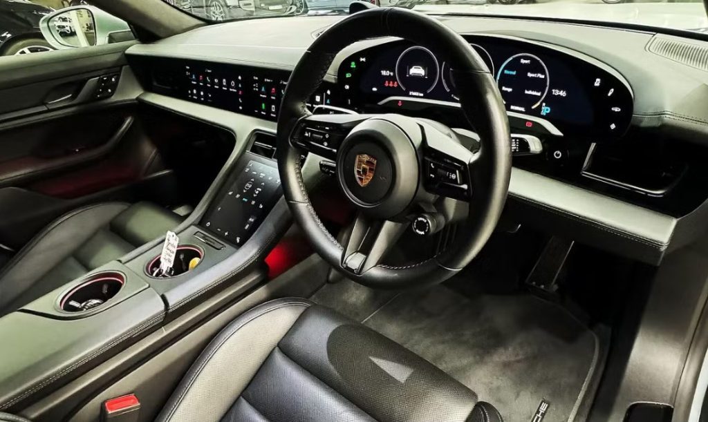 Steering wheel of the silver 2021 Porsche Taycan Turbo, available for hire in Sydney