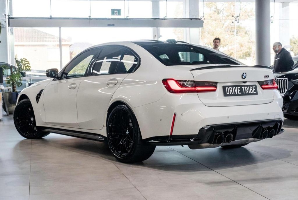 White 2024 BMW M3 Competition G80 xDrive, rear three-quarter view, available for hire in Sydney