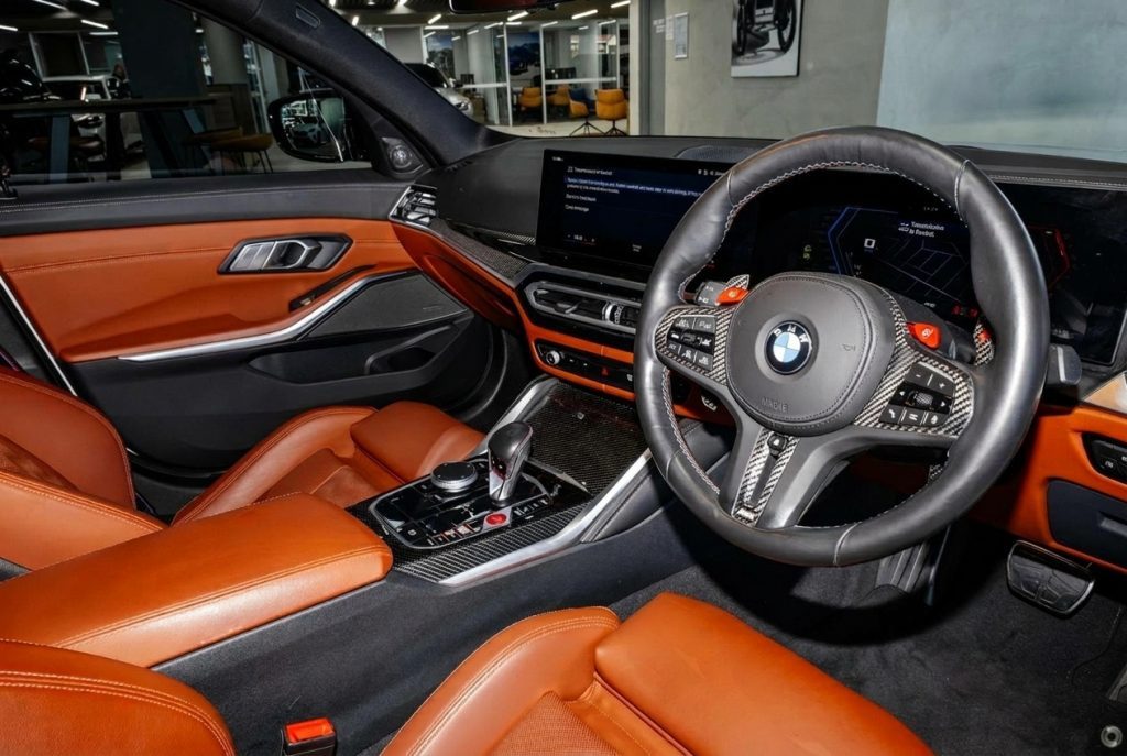 Steering wheel of the white 2024 BMW M3 Competition G80 xDrive, available for hire in Sydney