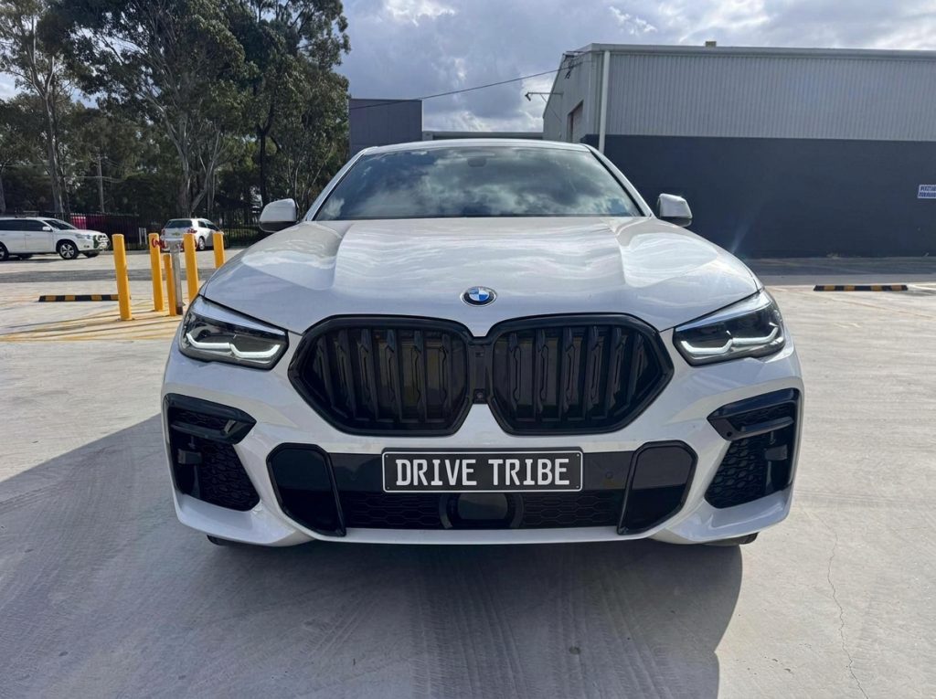 White 2022 BMW X6 xDrive40i M Sport, front view, available for hire in Sydney