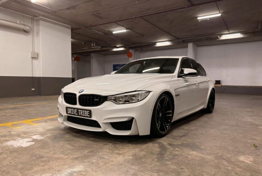 White 2016 BMW M3 Competition F80, front three-quarter view, available for hire in Sydney