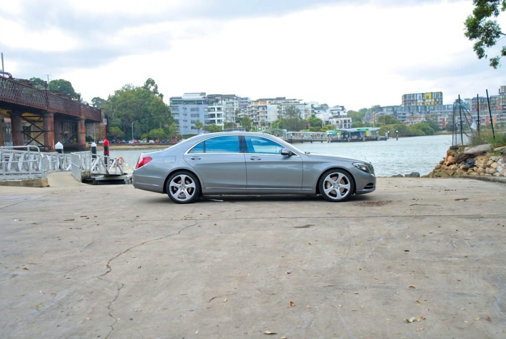Silver 2015 Mercedes-Benz S500 L, side profile, available for hire in Sydney