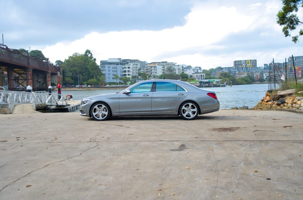 Silver 2015 Mercedes-Benz S500 L, side profile, available for hire in Sydney