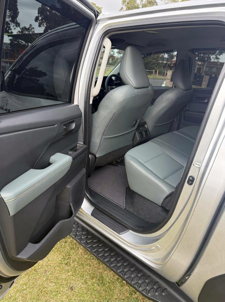 Rear seats of the silver 2026 Toyota HiLux Rogue 4x4, available for hire in Sydney