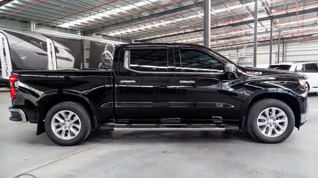 Black 2022 Chevrolet Silverado 1500 Trail Boss, side profile, available for hire in Sydney