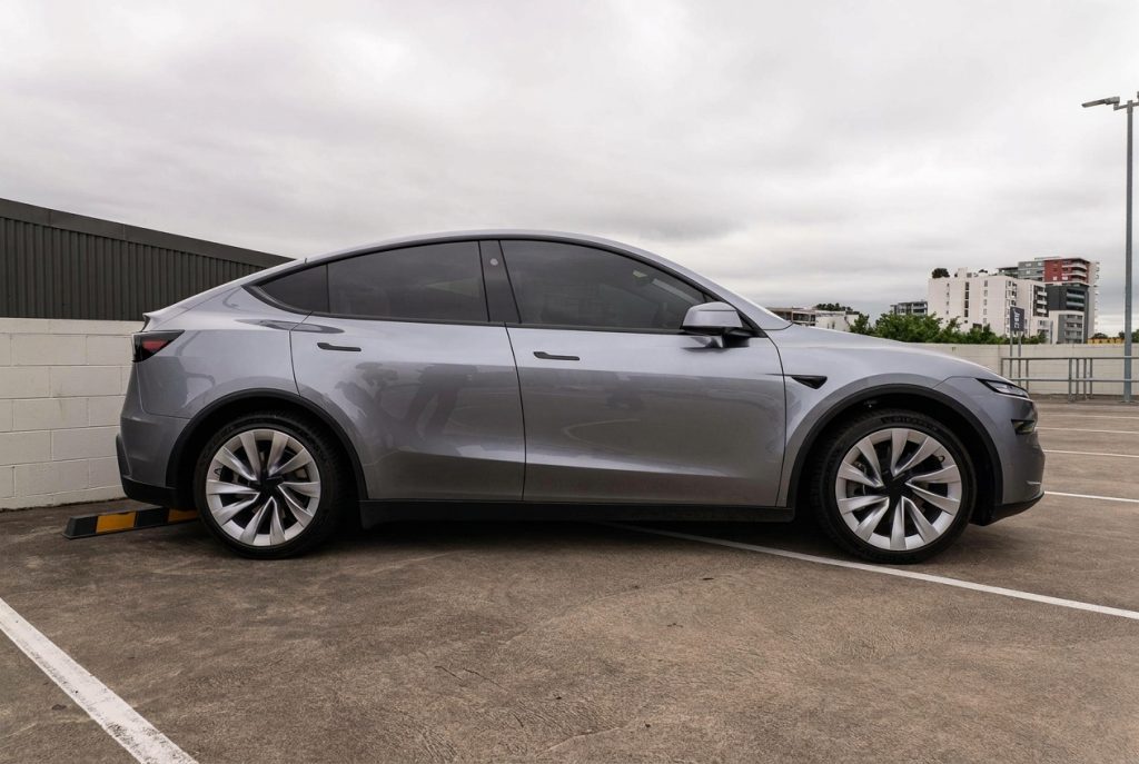 Silver 2025 Tesla Model Y RWD, side profile, available for hire in Sydney