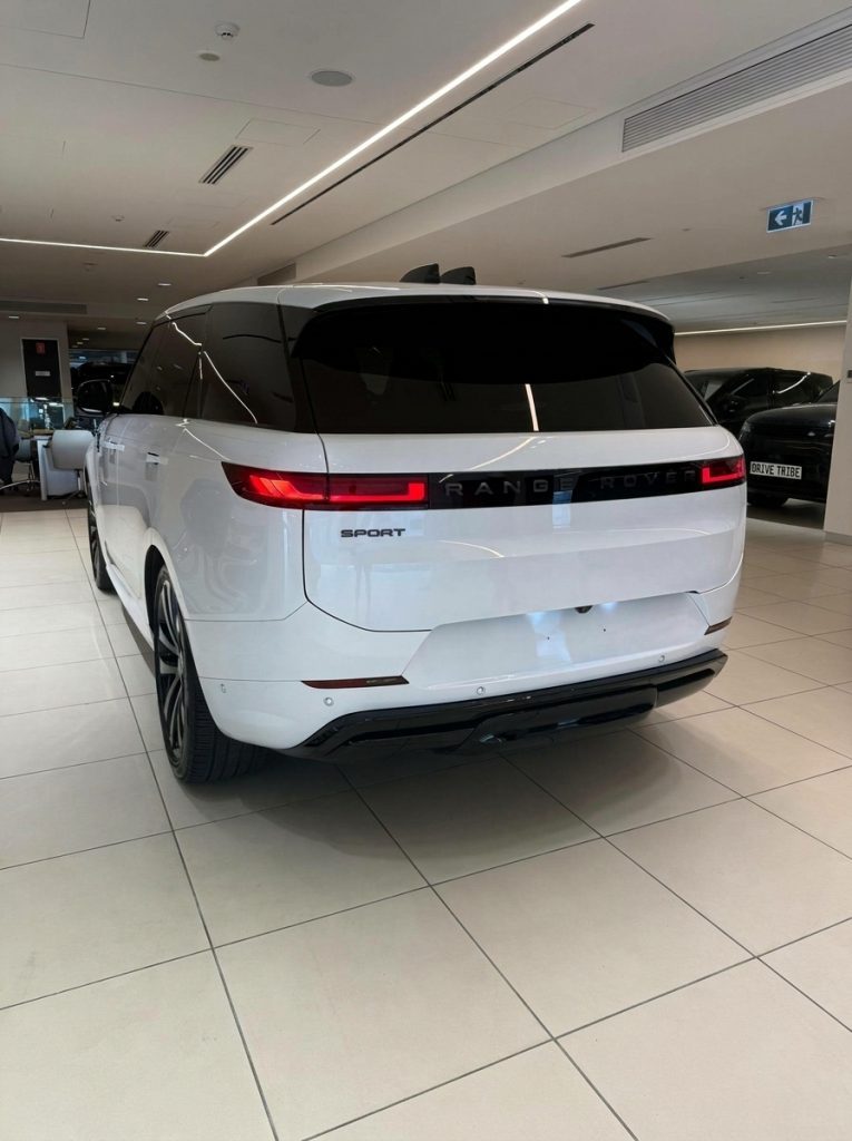 White 2024 Land Rover Range Rover Sport D300 SE Dynamic, rear three-quarter view, available for hire in Sydney