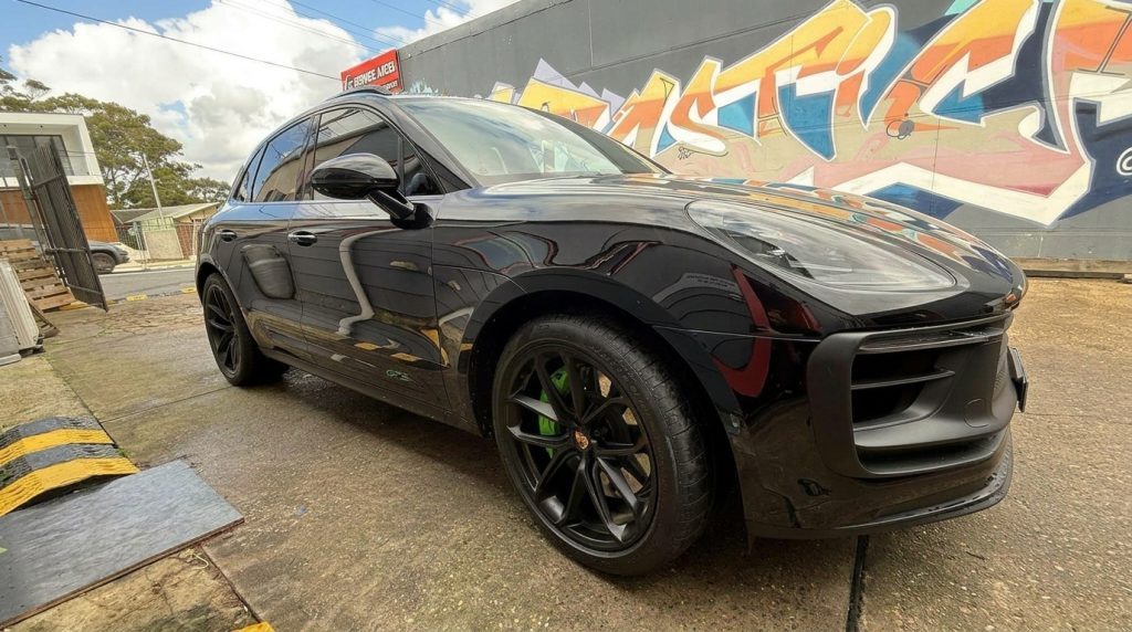 Black 2024 Porsche Macan GTS, front three-quarter view, available for hire in Sydney