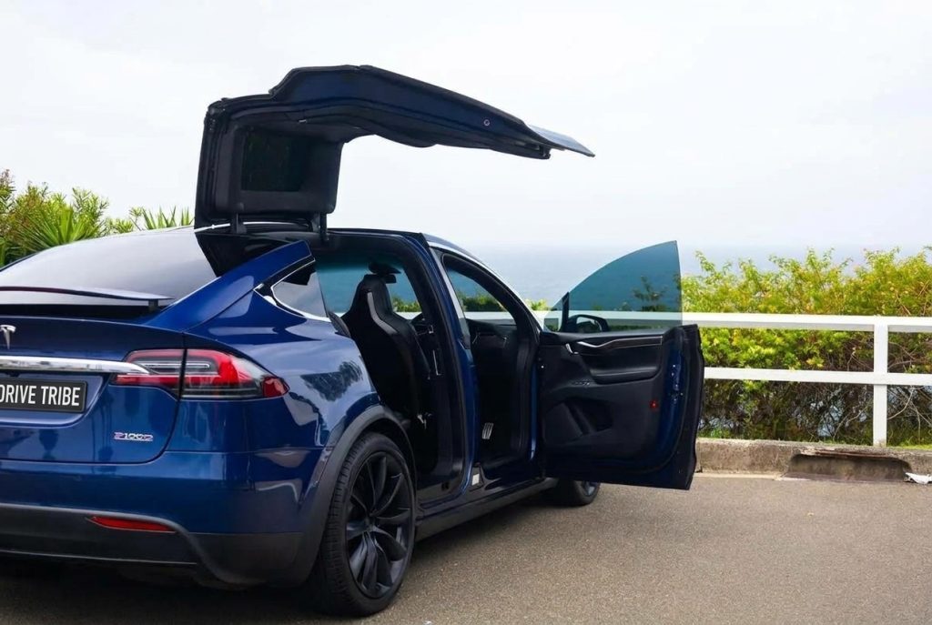 Blue 2017 Tesla Model X P100D, rear three-quarter view, available with a chauffeur in Sydney