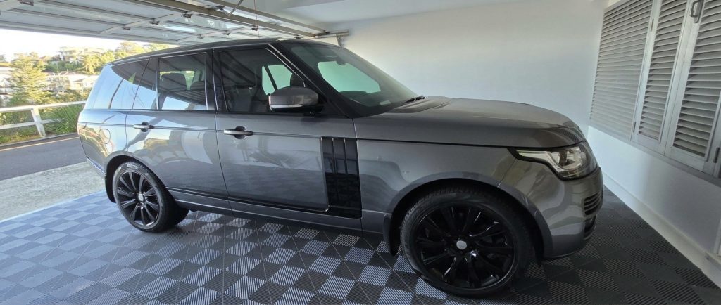 Grey 2013 Land Rover Range Rover Vogue, side profile, available for hire in Sydney